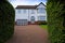 Typical 1930s white detatched house with driveway