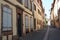 Typical Alsatian architecture in a narrow street in Colmar, France paved with cobblestones. The houses are properly maintained and