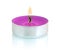 Typical aluminium burning purple tealight candle isolated on white background with shadow reflection.