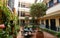 Typical Andalusian patio with fountain and numerous plants on the walls