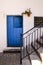 Typical Andalusian whitewashed facade with blue wooden door