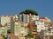 Typical apartment building in pastel colors on a hill with viewpoint in Lisbon, Portugal