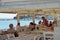 Typical atmosphere of a Greek tavern with customers having lunch near the sea