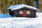 Typical black Norwegian cabin in the winter