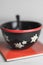 Typical black swiss cereal bowl with edelweiss on the side on a