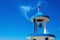 Typical blue-white church tower (steeple) with bell of greek church against blue sky