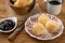 Typical brazilian cheese bun in a basket, coffee and jam