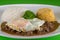 Typical Brazilian dish, diced meat, rice, cabbage and fried egg,green background