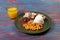 typical Brazilian food dish with rice, red beans, pork and carrot salad and braised corn
