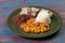 Typical Brazilian food dish with rice, red beans, pork and carrot salad and braised corn