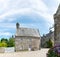 Typical Breton stone houses and hortensia in the picturesque French village of Locronan