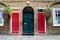 Typical British doors with doorbell in London. Two colorfull doors