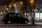 Typical British taxi cab TX4 in the night streets of Edinburgh with usual dark colour