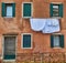 Typical city corner with ancient colorful buildings Drying clothes on a clothes-line in outdoor at sunny summer day. Venice