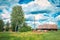 Typical, classic Russian house in the village. Russian rural farmstead with a barn, haystacks, firewood. Illustration