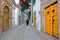 Typical cobbled and narrow street Dar el Jeld street with colorful doors, columns and arcades inside the historical medina