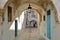 Typical cobbled and narrow street Dey street with colorful doors and arcades inside the historical medina of Tunis