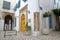 Typical cobbled and narrow streets with colorful doors, columns and arcades inside the historical medina of Tunis