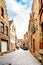 Typical cobblestone street with brick houses with step gables in the historic city of Bruges, Belgium