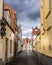 Typical cobblestone street with brick houses with step gables in the historic city of Bruges, Belgium