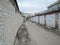 Typical complex of old concrete garages with closed metallic doors in Russia. driveway road through garages with