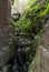 Typical corner with a small waterfall with moss crossing the streets in Robledillo de Gata