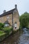 Typical cottage across the River Windrush in Bourton-on-the-Water, also known as The Venice of the Cotswolds - Gloucestershire