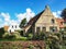 Typical cottages on the island Ameland under a blue sky