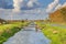 Typical Dutch flat polder landscape with cana and bridges