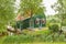 Typical Dutch green wooden house with water channel and garden