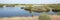 Typical dutch landscape panorama with river de Waal, uiterwaarden, vegetation, water on a bright sunny day