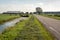 Typical Dutch polder landscape with a country road between the m