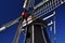 Typical Dutch windmill detail against a blue sky, Holland.
