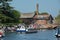 Typical english river scene with large tour boat and factory in background