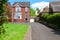 Typical English single family house built of red bricks, with a large driveway