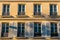 Typical facade of Parisian building with window wrought iron fences. France