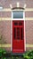 A typical front door red color of one of the houses in the Netherlands. Vertical view