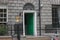 A typical Georgian doorways in Dublin, Ireland - green wooden entrance door