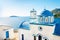 Typical Greek blue dome of white church with sea view in sunny d
