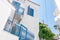 Typical Greek Island whitewashed and blue architecture with broom and mop on cobalt blue wrought iron