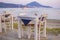 Typical Greek seaside tavern table with wooden chairs by the sea coast in Gialova near Pylos city, Messinia, Greece