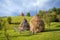 Typical hay bales and meadows of green grass and blue sky. Rural scene.