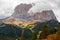 Typical hilly mountain landscape in the Dolomites with beautiful autumn colors on a foggy morning near the town of Cortina dâ€™