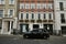 Typical house in Mayfair London with a typical black cab