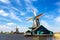 Typical iconic landscape in the Netherlands, Europe. Traditional windmills with a river in Zaanse Schans village. Famous tourist