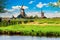 Typical iconic landscape in the Netherlands, Europe. Traditional windmills in Zaanse Schans village. Famous tourist attraction in