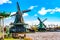 Typical iconic landscape in the Netherlands, Europe. Traditional windmills in Zaanse Schans village with vintage bicycle. Famous