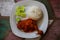 Typical Indonesian Dish: Nasi Ayam Plecing Chicken with rice and special sauce bird`s-eye