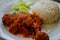 Typical Indonesian Dish: Nasi Ayam Plecing Chicken with rice and special sauce close-up