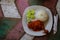 Typical Indonesian Dish: Nasi Ayam Plecing Chicken with rice and special sauce copy space left